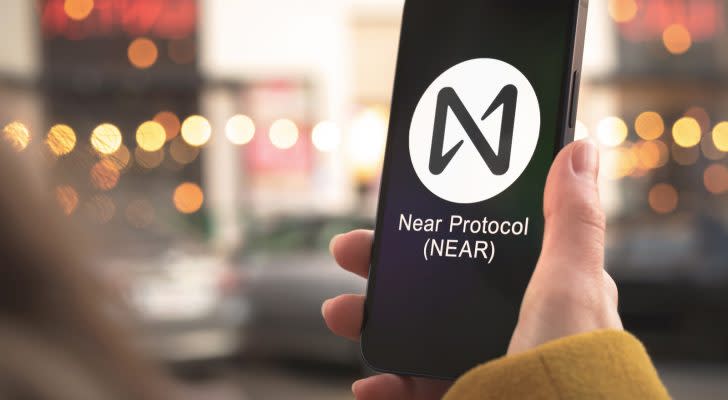 NEAR Protocol (NEAR-USD) logo on a smartphone held by a person