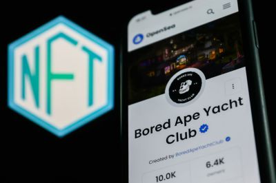 The Bored Ape Yacht Club collection in OpenSea displayed on a phone screen and the NFT logo displayed on a screen are seen in this illustration photo taken in Krakow, Poland on April 19, 2022. (Photo by Jakub Porzycki/NurPhoto via Getty Images)