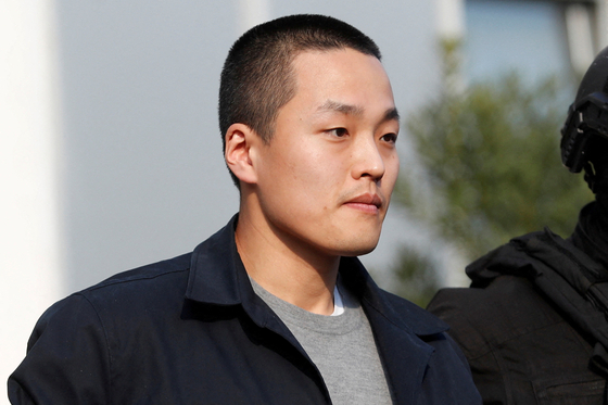 Do Kwon, co-founder of Terraform Labs, is escorted by police officers in Podgorica, Montenegro, on March 23. [REUTERS/YONHAP]