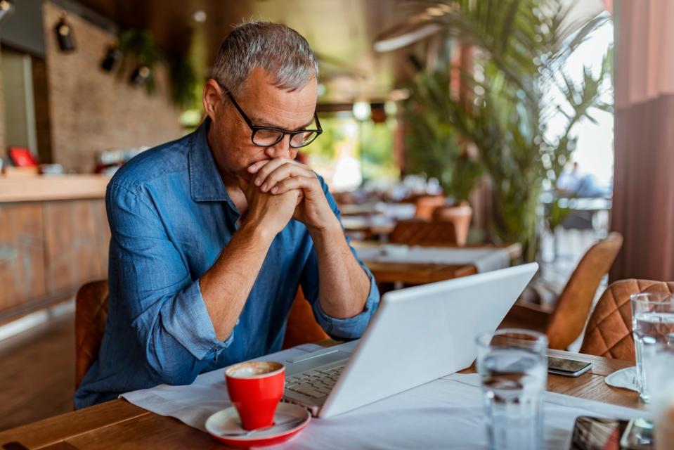 Serious looking investor with laptop.