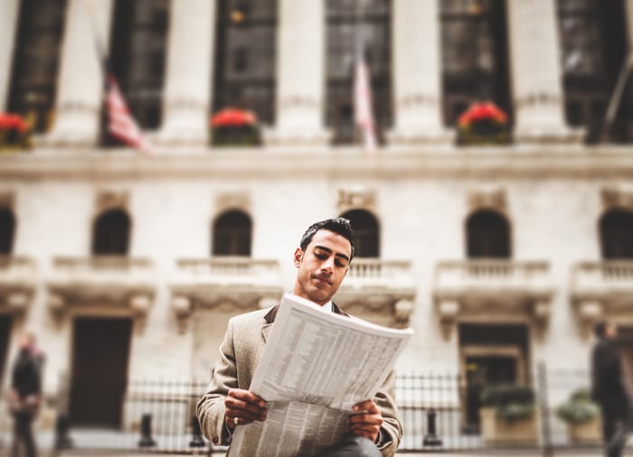 Wall Street trader with newspaper.