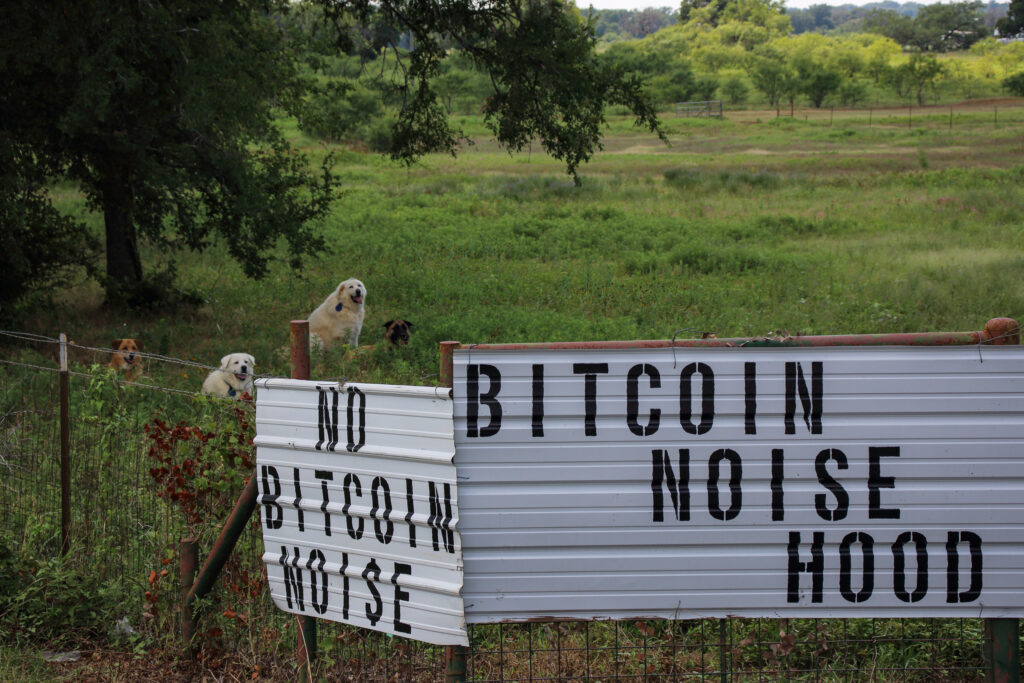 Signs are displayed on the fence of Cheryl Shadden’s property in Granbury, Texas. Credit: Keaton Peters/Inside Climate News